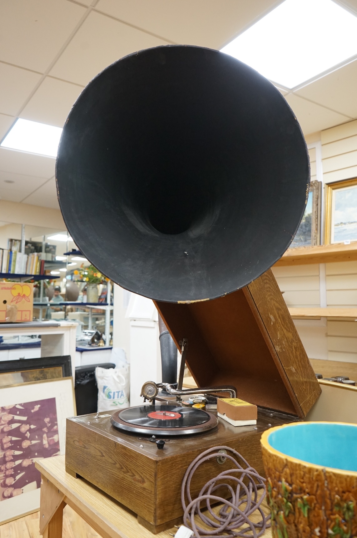 An EMG ‘Handmade Gramophone’ with electrically powered motor, in an oak veneered case with large papier-mâché horn, dimensions of the case; 44 x 53 x 27cm, diameter of the horn 56cm.